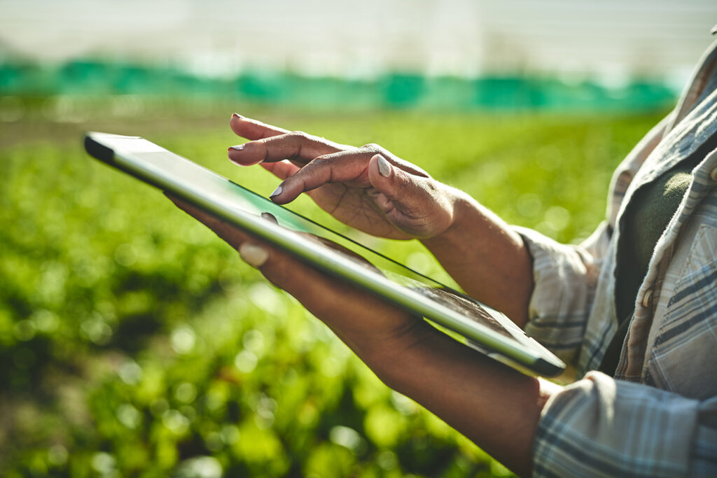 Shot of an unrecognisable woman using a digital tablet while working on a farm