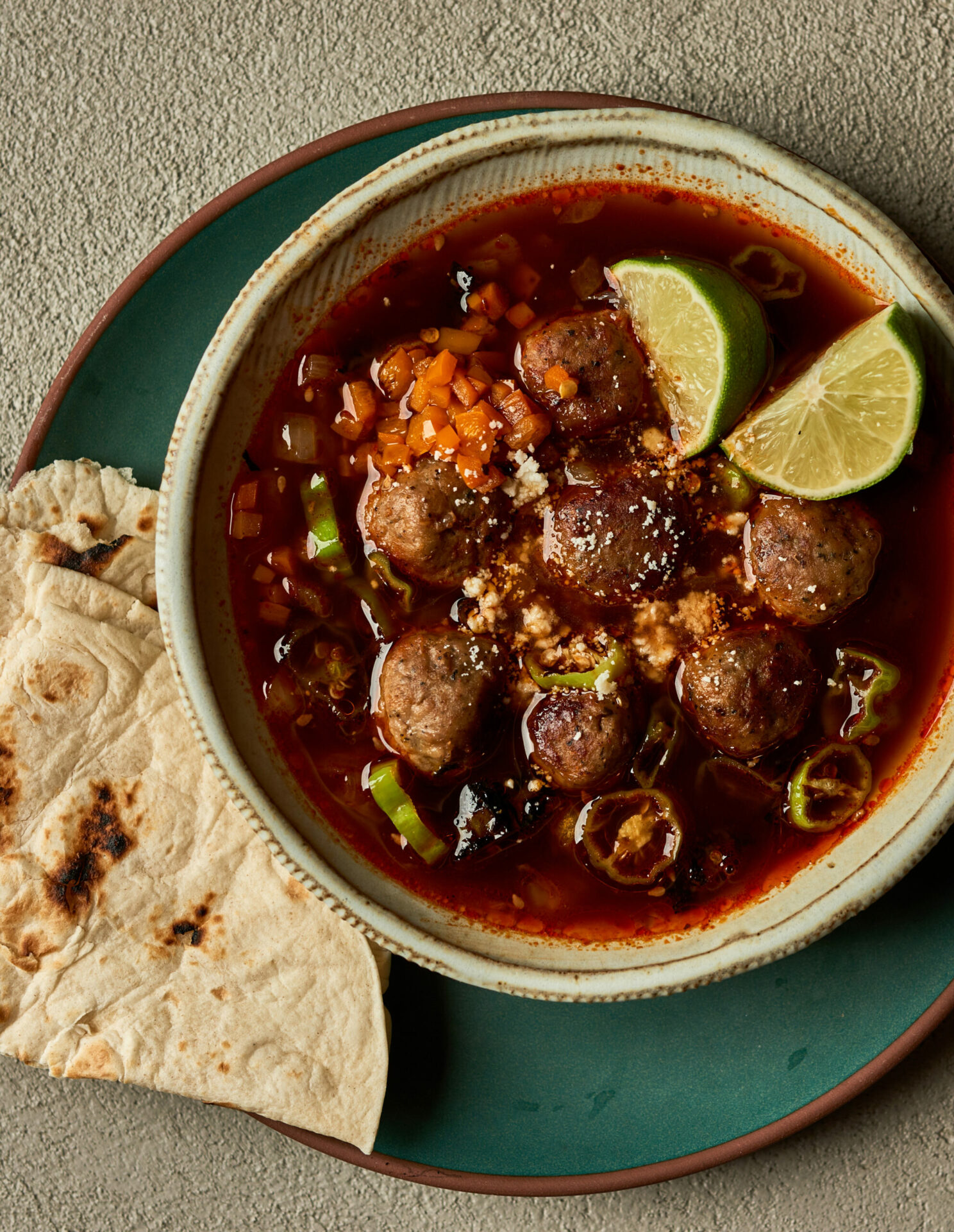 Albondigas meatball soup in a bowl with a tortilla on the side